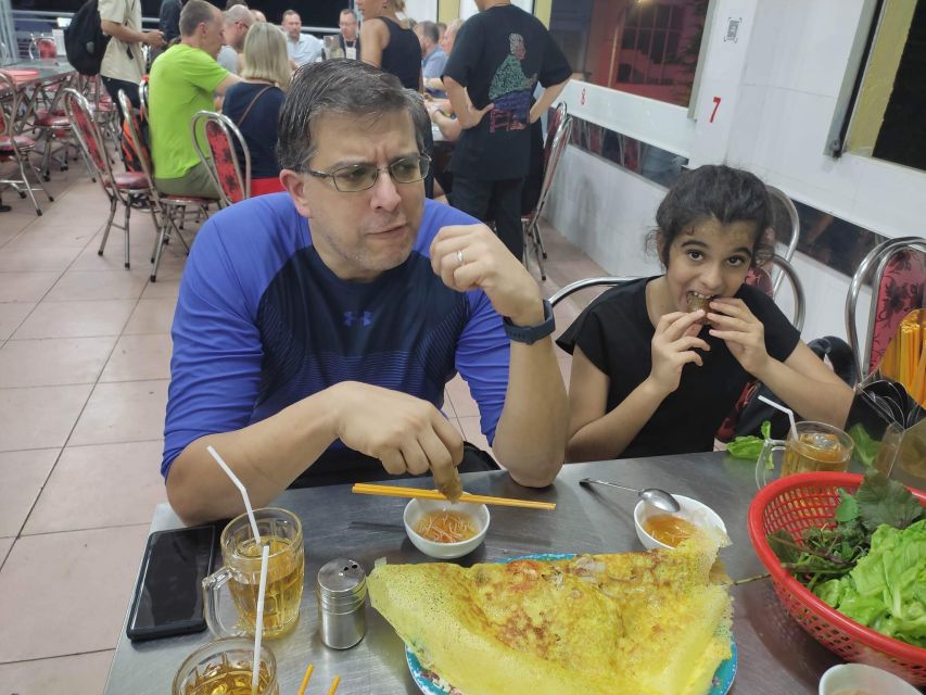 Saigon: Night Sightseeing And Street Food Tour By Vespa - From District 5 fashion streets to District 4 bread: crispy, loaded, fast